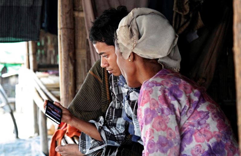 A couple views information on a smartphone